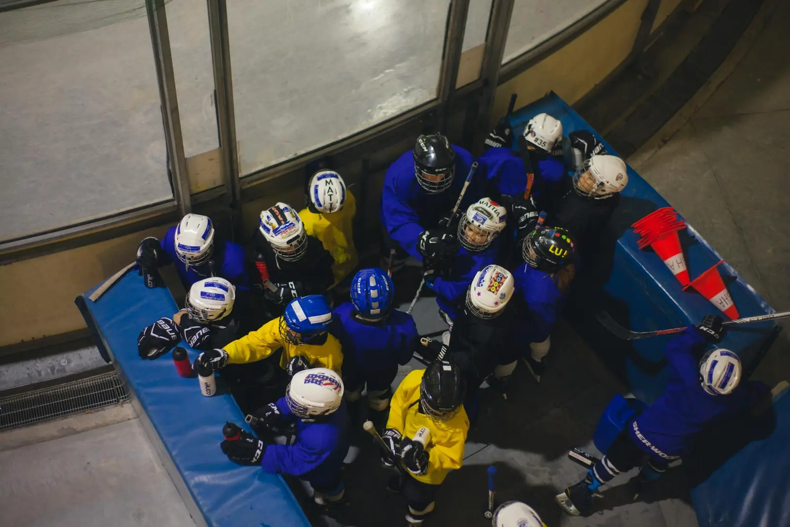 Youth hockey team huddled together on the bench